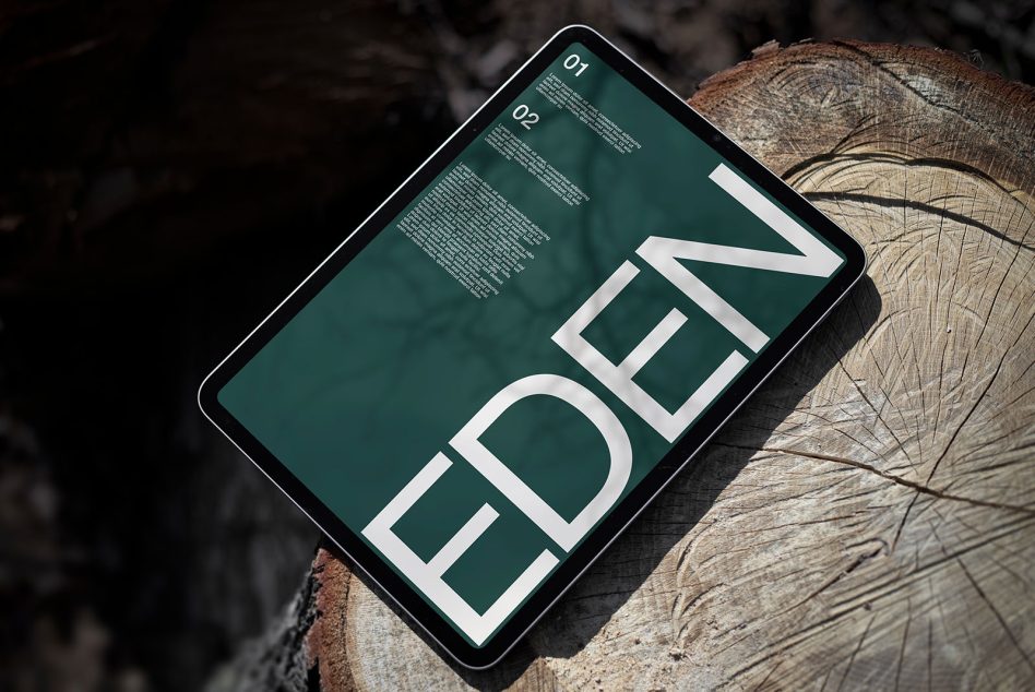 Digital tablet mockup on a wooden surface displaying bold font design with text "EDEN," ideal for showcasing font templates and graphics.