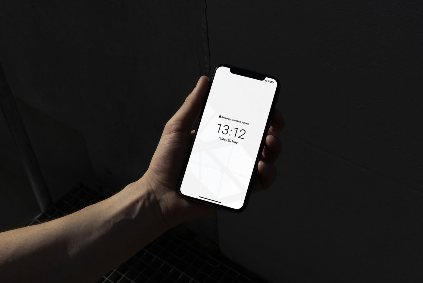 Hand holding smartphone mockup with blank screen and modern design, ideal for UI/UX presentation in a realistic setting.