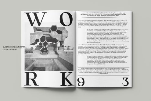 Open magazine spread with large serif typography, geometric sculpture photo, body text