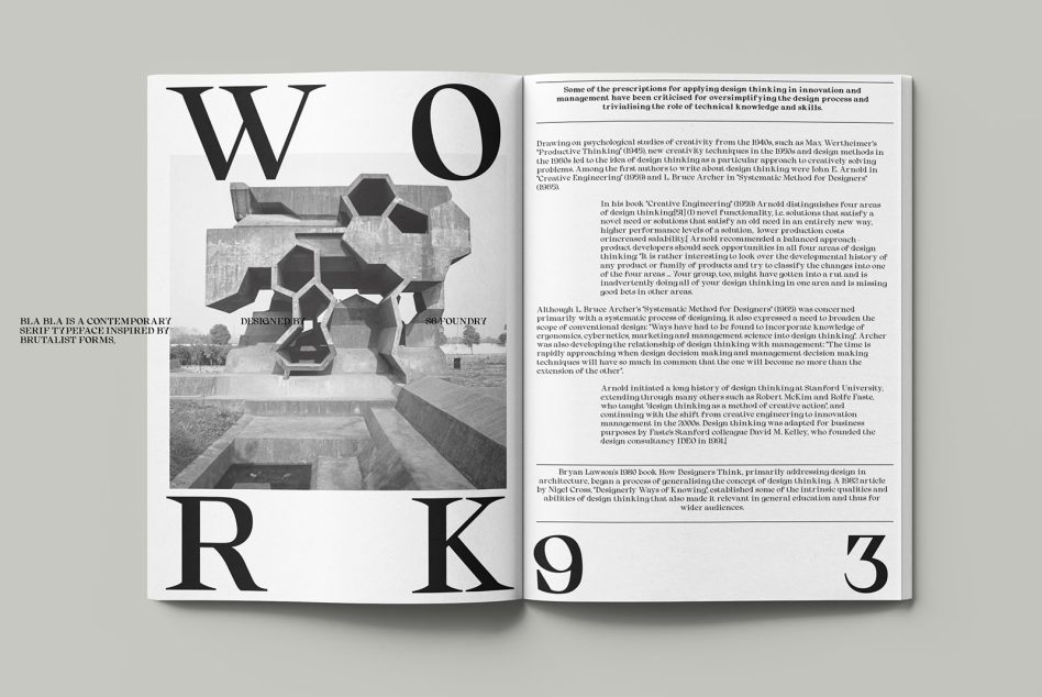 Open magazine spread with large serif typography, geometric sculpture photo, body text
