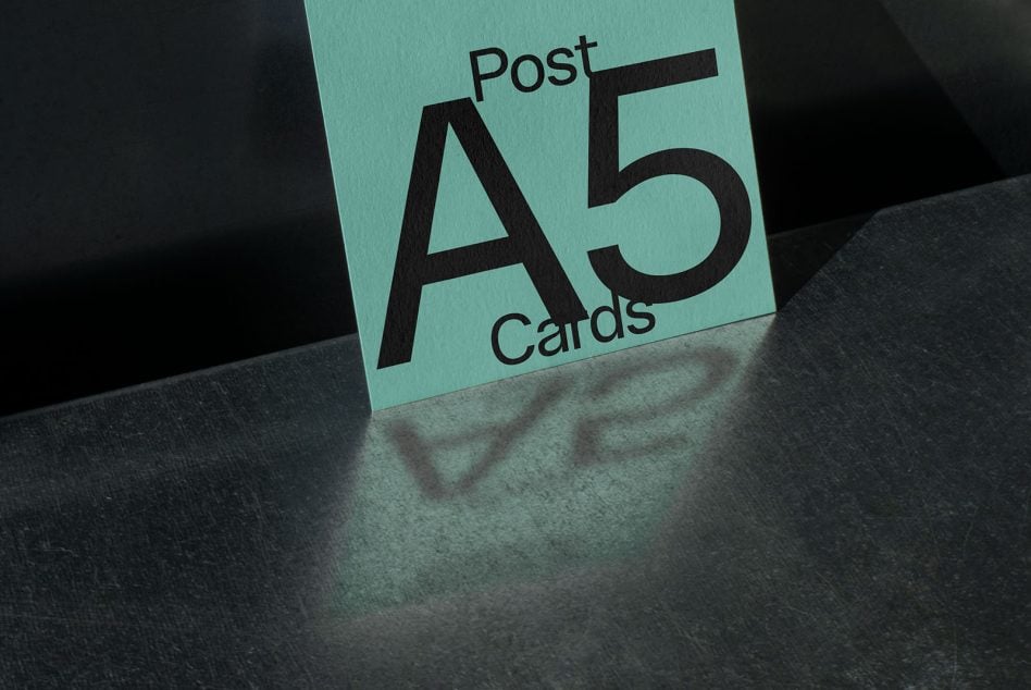 Close-up of turquoise A5 card mockup with Post Cards typography visible