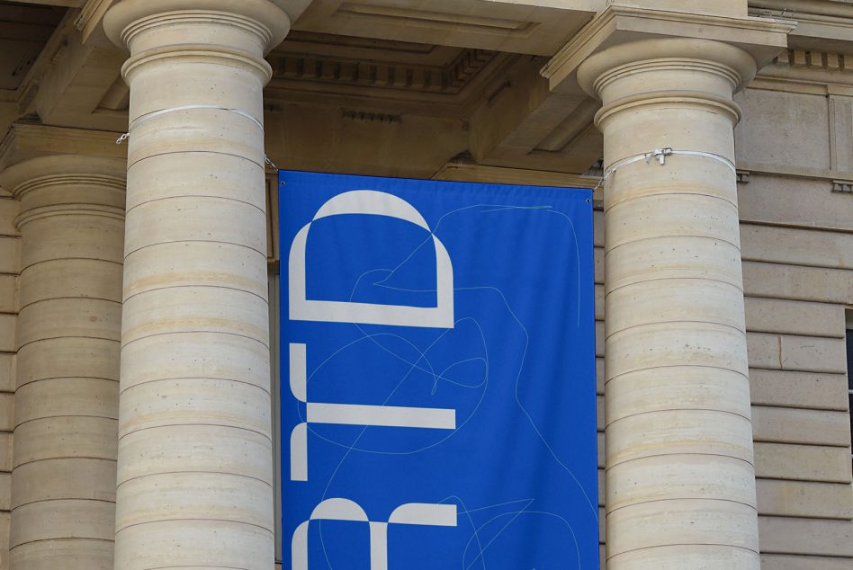 Blue banner mockup hanging between stone pillars, displaying abstract white design, suitable for graphic presentations and branding.