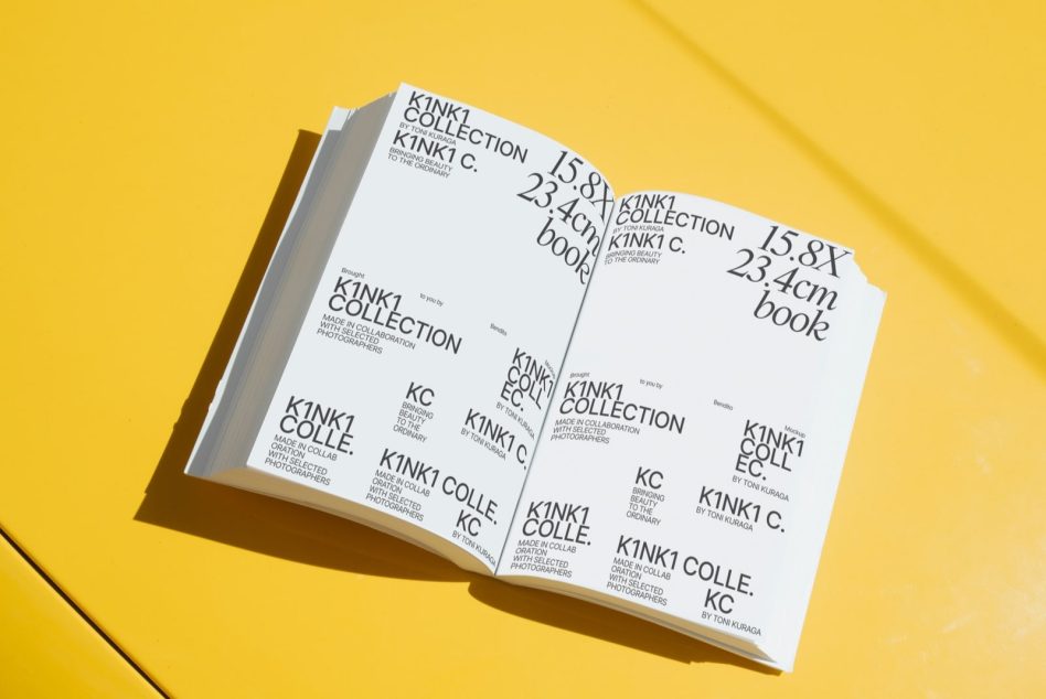 Opened book on yellow surface showing full Kinki Collection layout with text blocks