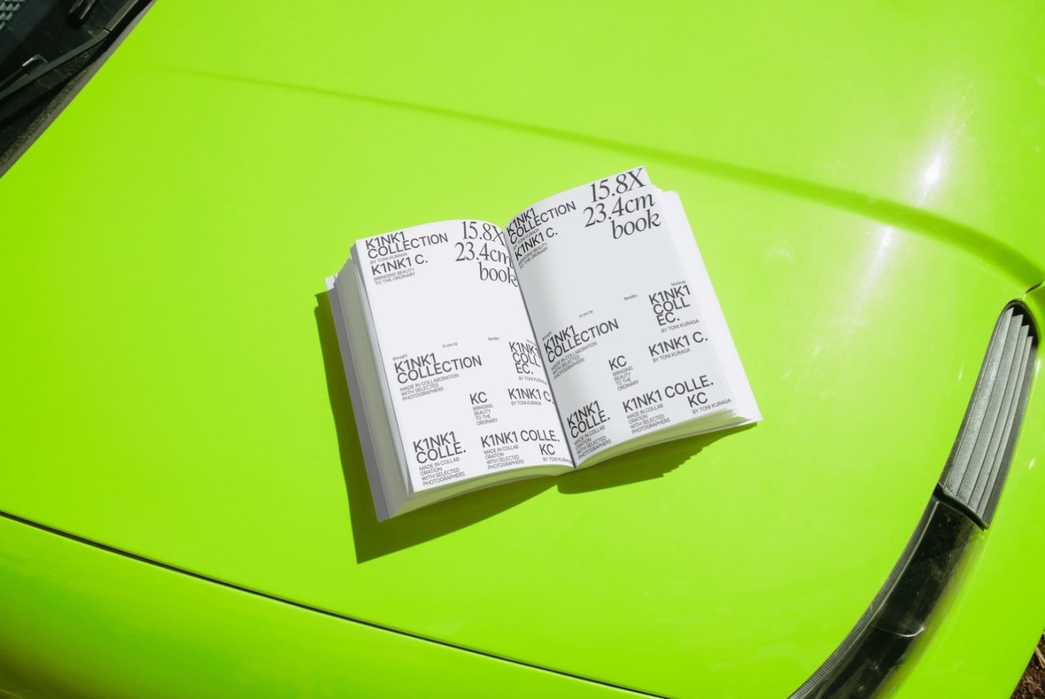 Print design book mockup on vibrant green background, exposed to sunlight, showcasing cover and interior pages for presentations.