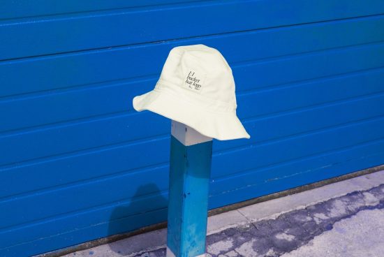 Mockup of a cream bucket hat with space for your design on vibrant blue background, ideal for showcasing fashion accessories.