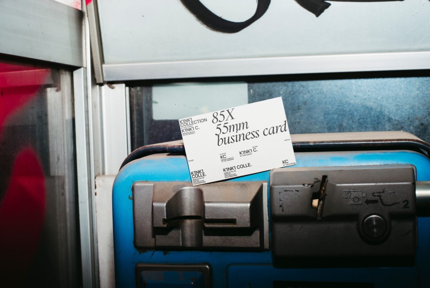 Urban setting business card mockup on a gritty blue metal surface, showcasing clean design and typography for graphic designers.