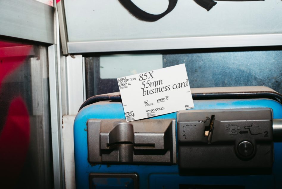 Urban setting business card mockup on a gritty blue metal surface, showcasing clean design and typography for graphic designers.