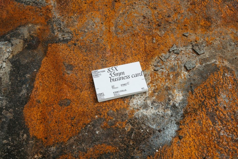Business card mockup on rust orange weathered concrete ground texture