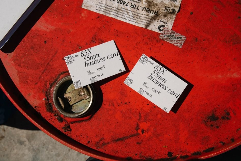 Two business card mockups on red industrial drum with metal lock detail