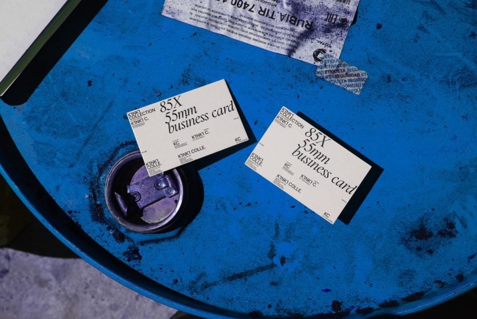 Two business card mockups on blue industrial drum with purple metal lock