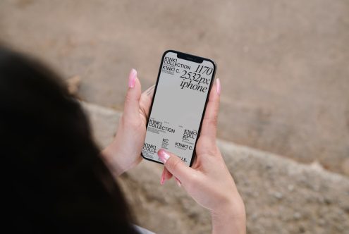 Woman holding smartphone showcasing screen mockup for design presentation, digital asset for graphic designers, clear display template.