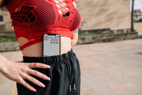 Woman in red mesh top and black pants with smartphone in pocket, urban style, modern fashion mockup.