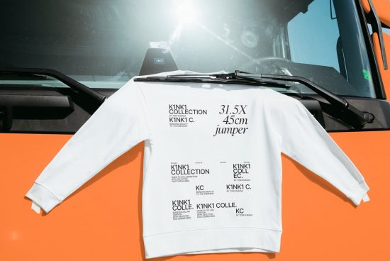 White branded sweatshirt draped over truck dashboard for a mockup, with clear text detail, highlighting modern fashion design.