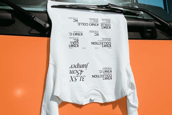 White T-shirt Mockup for typography on vibrant orange backdrop, modern apparel design presentation, top view fashion concept.