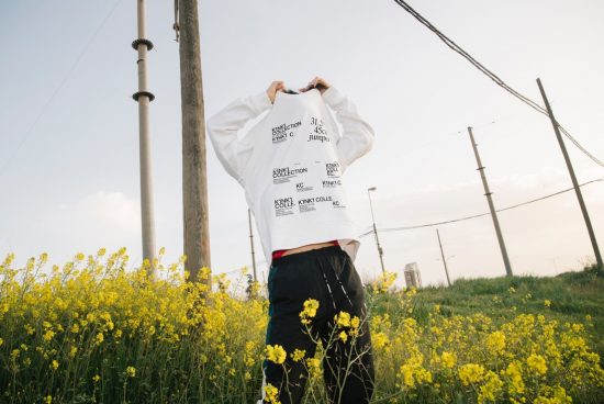 Person in a field with typography sweatshirt design mockup, fashion, outdoor photoshoot, designer apparel template, casual clothing graphic.