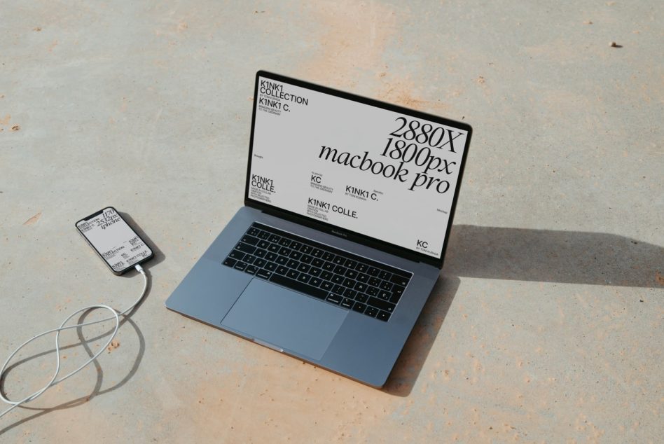 Laptop and smartphone mockup on concrete surface, showcasing device screen templates, ideal for presenting app and web designs to clients.