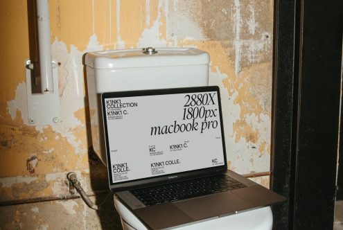 Laptop mockup with screen displaying design dimensions, placed on a toilet tank in a grunge setting, ideal for presentations, digital design, and portfolio.