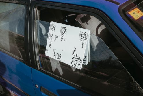 Mockup of magazines in car window reflecting urban setting, offering a realistic context for design presentation.