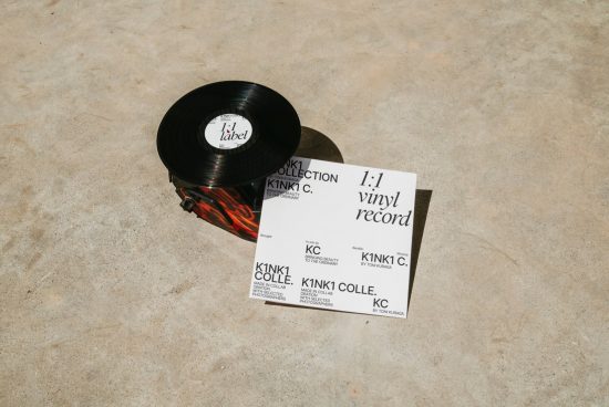Vinyl record and label mockup on concrete surface for album cover design presentation, music-related graphic templates, modern branding display.