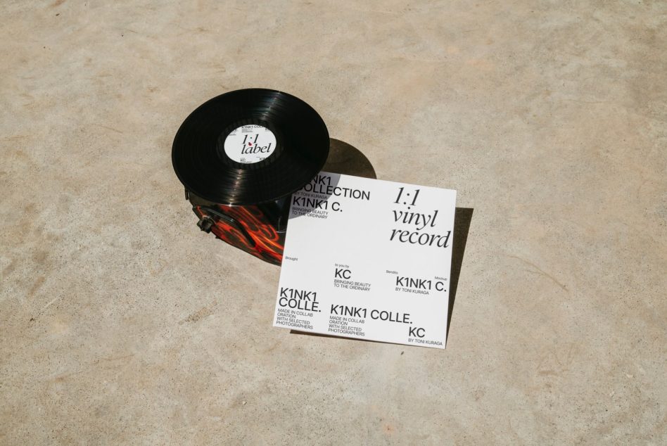 Vinyl record mockup with white sleeve lying flat on concrete surface