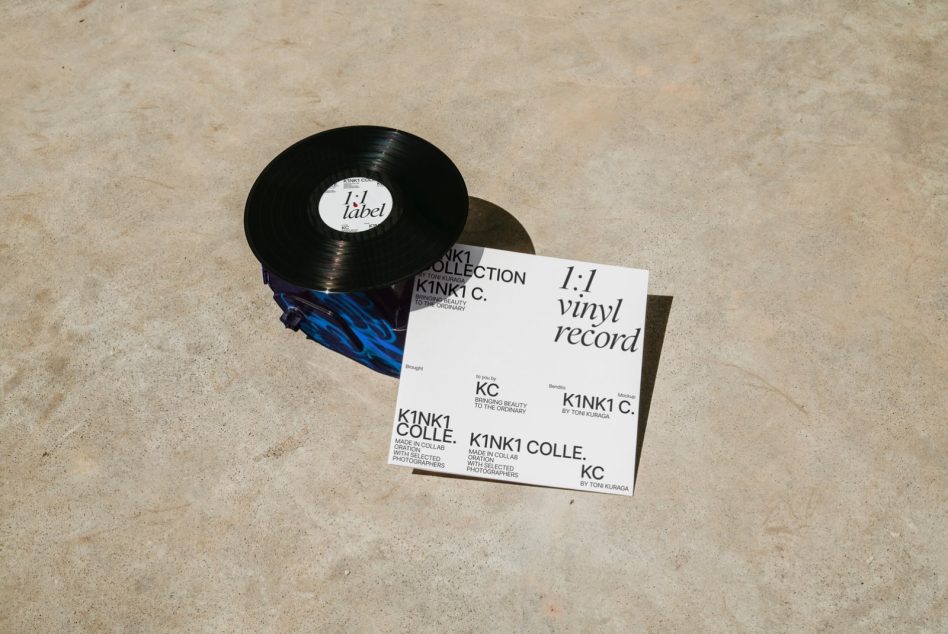 Black vinyl record mockup with colorful sleeve displayed on concrete