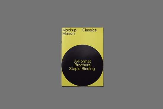 Minimalist A-format brochure mockup with staple binding, featuring a yellow cover and black circle design on a grey background.