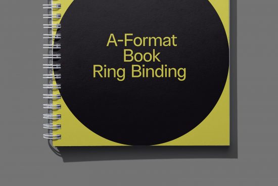 Spiral notebook mockup with A-format book ring binding, visible metallic spirals, yellow cover on gray background, graphic design resource.