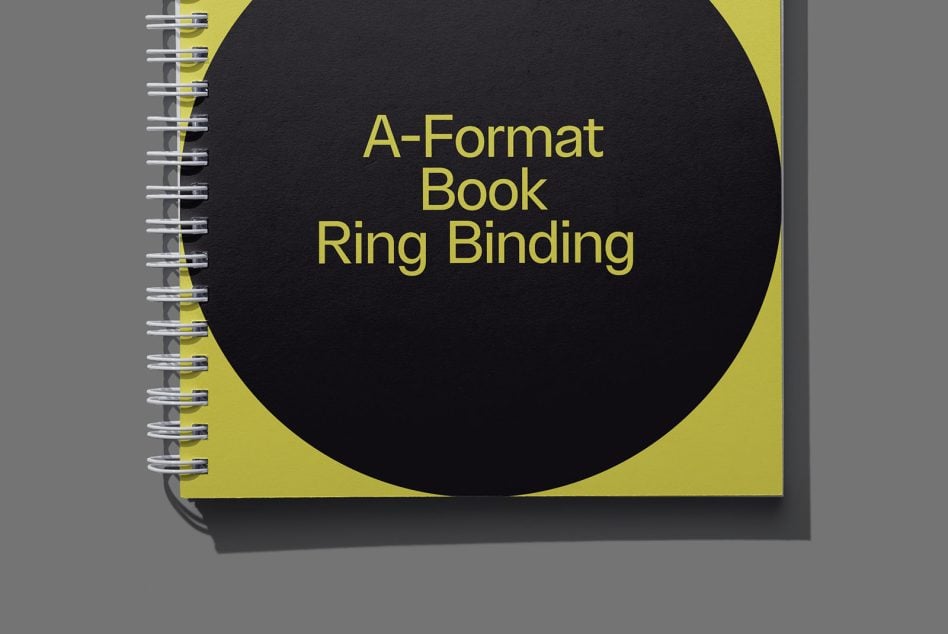 Spiral bound A-Format book with yellow cover, large black circle design