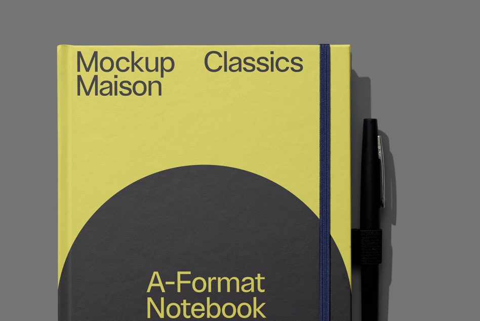 Yellow hardcover notebook with navy elastic band, large black circle design