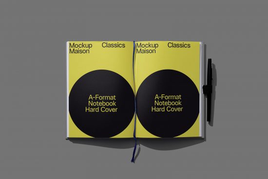 A-Format hardcover notebook mockup in yellow with black pen, open book design on grey background, ideal for branding presentations.