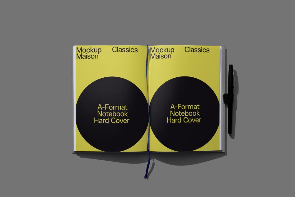Open hardcover book showing two yellow pages with matching black circles