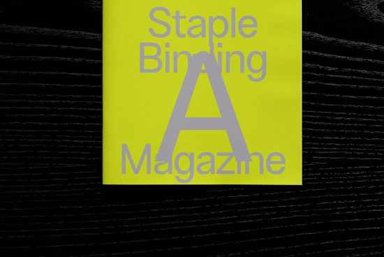 Neon yellow magazine cover mockup with staple binding on a textured black background, ideal for design presentations and portfolio graphics.