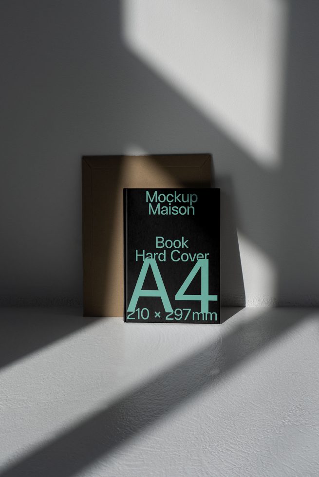 Elegant A4 hardcover book mockup with shadow overlay, realistic lighting, ideal for presenting cover designs, standing against a textured wall.