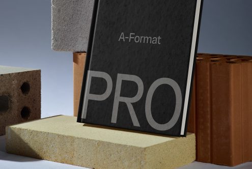 A-Format poster with bold PRO text mockup displayed on bricks for graphic designers to showcase typography and designs.