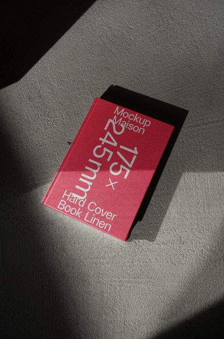 Hot pink hardcover book mockup with white text on concrete