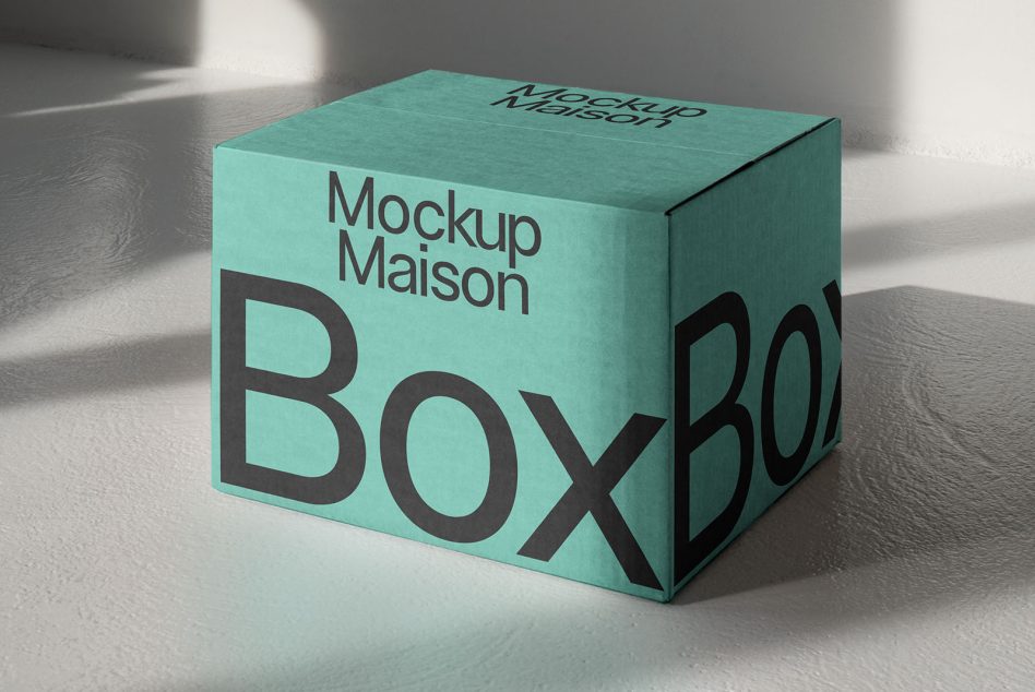 Teal square box mockup photographed from front angle with soft window shadows