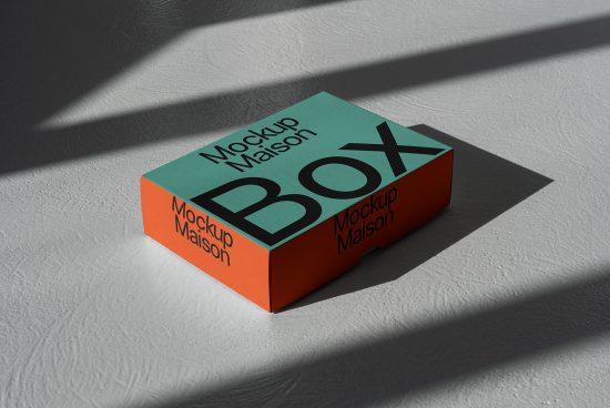 Elegant packaging box mockup on textured background with natural shadows, ideal for design presentations.