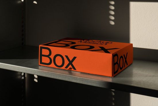 Orange mockup box on shelf with dramatic lighting, ideal for product packaging designs, presenting graphic branding concepts for marketers and designers.