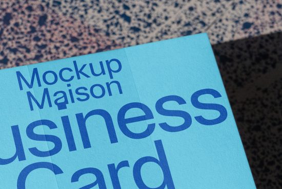 Close-up view of a blue business card mockup with stylish typography, ideal for designers seeking professional presentation tools.