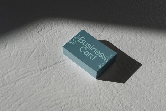 Stack of business cards mockup on textured surface with natural shadows, ideal for designers to present branding designs.