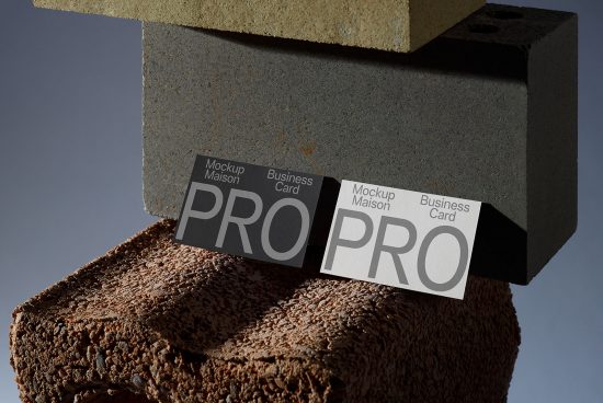 Business card mockup with stacked stones, showcasing PRO text design, for graphic designers, realistic texture and lighting.