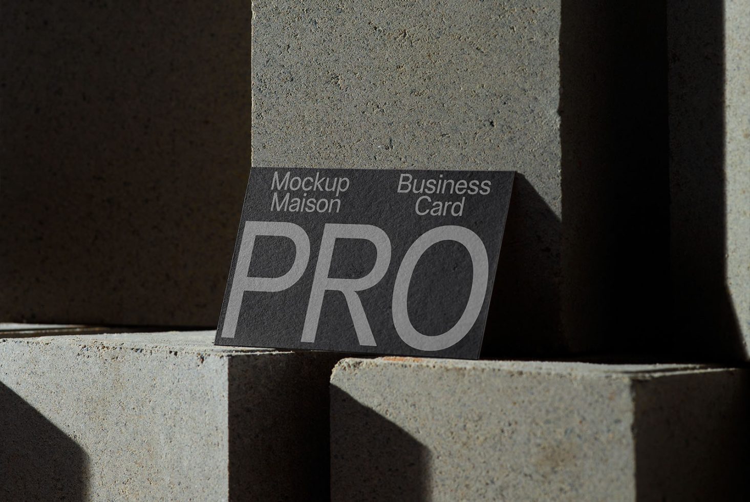 Professional business card mockup on textured surface with shadow, ideal for presentation and design display.