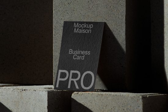Elegant business card mockup with shadow play on concrete for graphic design presentation, showcasing professional branding.