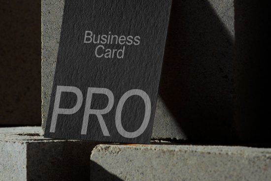 Professional business card mockup with shadow overlay on concrete texture, ideal for realistic branding and identity design presentations.