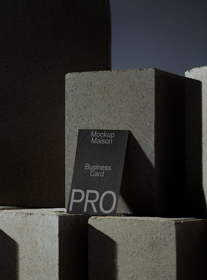 Elegant concrete texture business card mockup in dramatic lighting for designers to display professional branding projects.