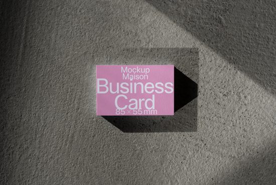 Purple business card mockup on textured grey background with natural shadows, ideal for designers to present branding.