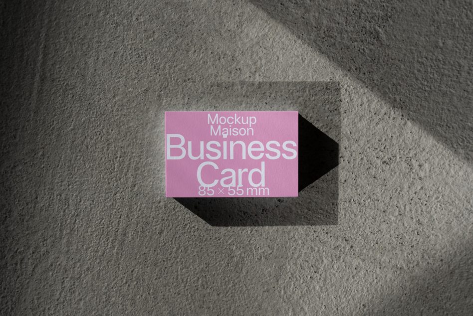 Single pink business card mockup centered with dramatic shadow