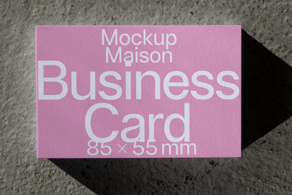 Large pink business card mockup lying flat on rough surface