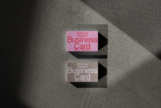 Two business card mockups with shadow overlay on textured background, highlighting realistic presentation for brand design.