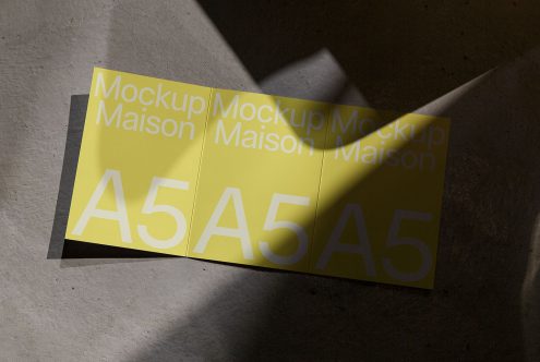 Yellow A5 paper brochure mockup in natural sunlight, perfect for designers to display graphics and fonts.